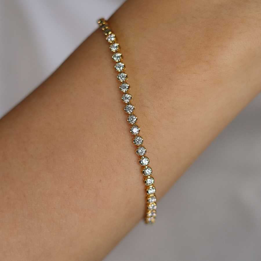 Bracelet with small stones on a wrist against a neutral background