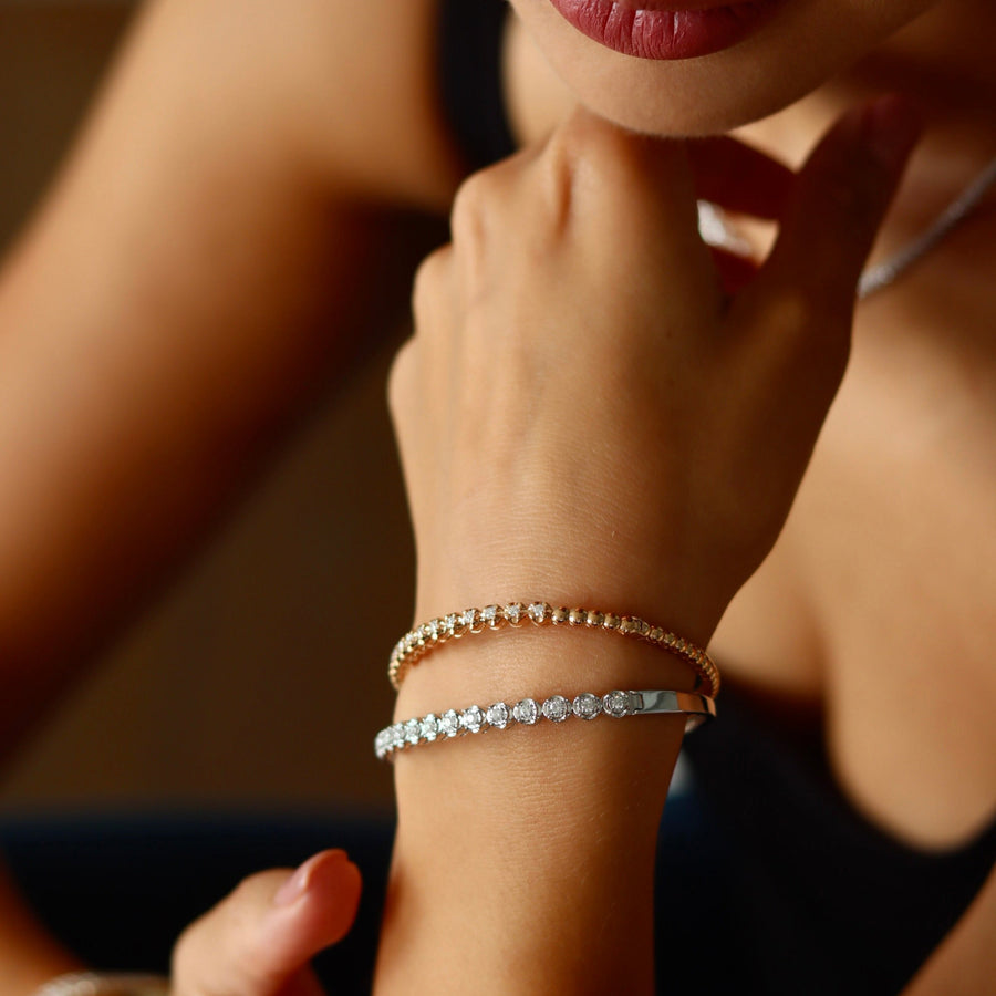 Close-up of a person wearing multiple bracelets on their wrist.